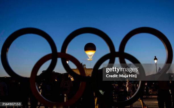 The Olympic cauldron is pictured trough Olympic rings as it stands high near Louvre Museum on day two of the Olympic Games Paris 2024 at on July 28,...