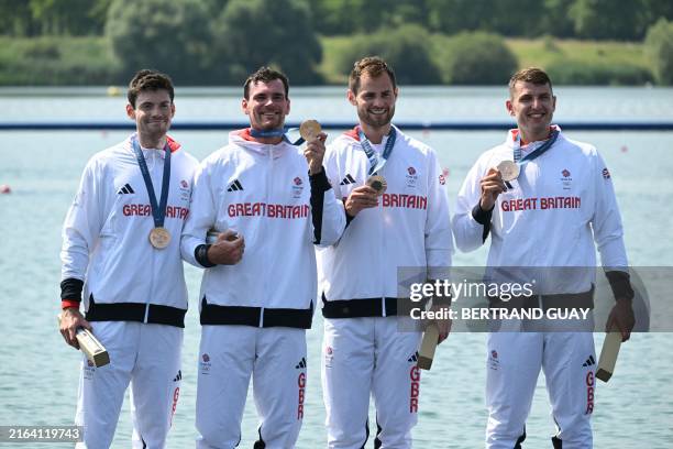 Great Britain's bronze medallists Oliver Wilkes, David Ambler, Matt Aldridge and Freddie Davidson pose on the podium during the medal ceremony after...