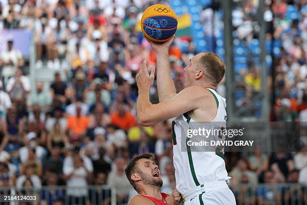 Lithuania's Aurelijus Pukelis goes for the basket past Poland's Przemyslaw Zamojski in the men's pool round 3x3 basketball game between Lithuania and...