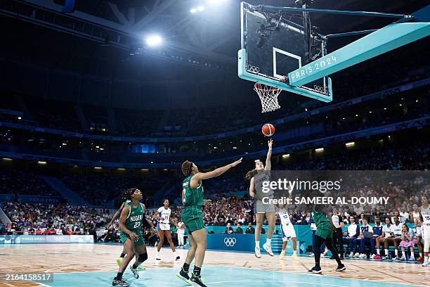France's Marine Fauthoux goes to the basket and scores in the women's preliminary round group B basketball match between France and Nigeria during...