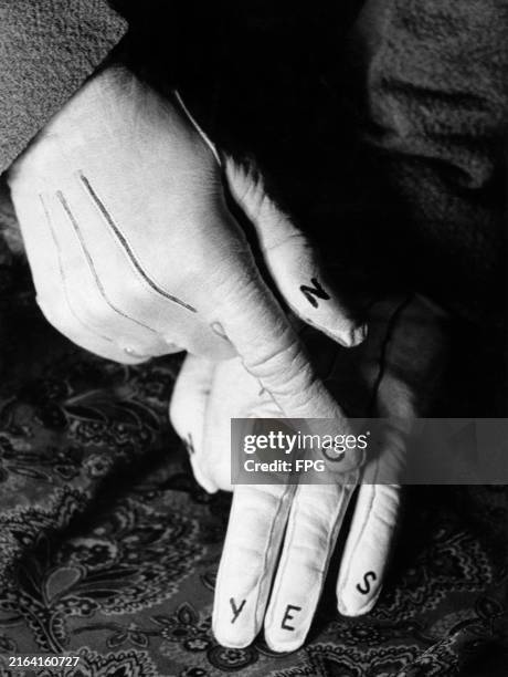 Gloves designed by a Frankfurt fashion house which have the words 'yes' and 'no' written on the fingers, circa 1950.