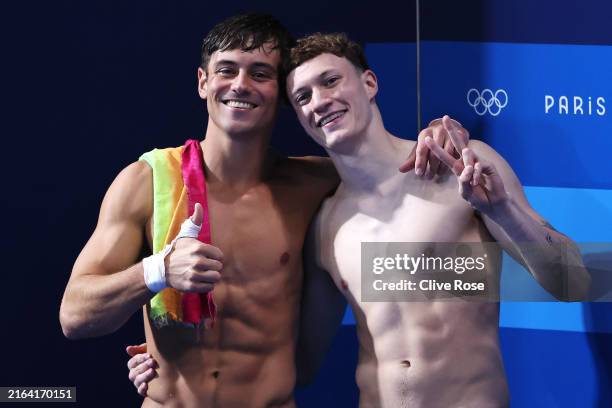 Thomas Daley, seen with a rainbow towel, and Noah Williams of Team Great Britain pose for a photo as they celebrate winning silver after competing in...