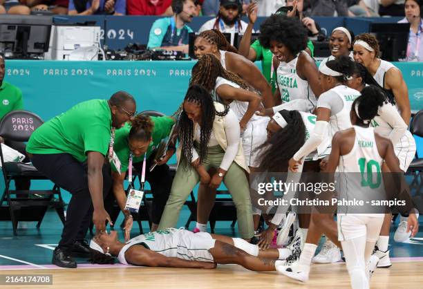 Team Nigeria celebrates with Ezinne Kalu of Nigeria during the Women's basketball Group Phase - B match between Team Nigeria and Team Australia on...