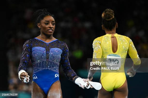 Simone Bile and Brazil's Rebeca Andrade compete in the artistic gymnastics women's all around final during the Paris 2024 Olympic Games at the Bercy...