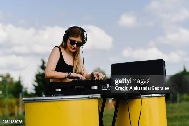 female dj showing turntable expertise - dj stock pictures, royalty-free photos & images