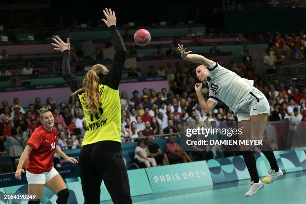 Germany's right wing Jenny Behrend shoots past Denmark's pivot Rikke Iversen during the Women's Preliminary Round Group A handball match between...