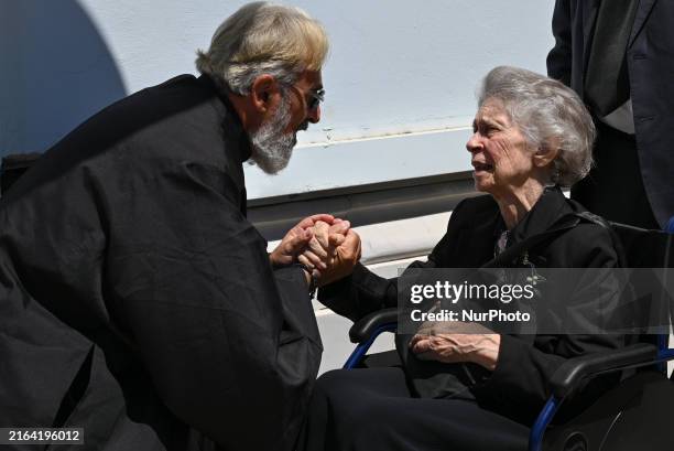 Princess Irene of Greece is talking to a Greek Orthodox priest at the funeral of Prince Michael of Greece in Athens, Greece, on August 1, 2024.
