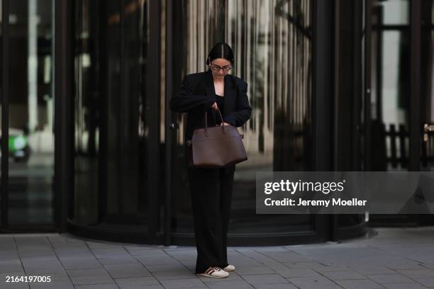 Maria Barteczko seen wearing Miu Miu brown retro Regard optical glasses in acetate, COS black cropped top, Papermoon black shoulder padded blazer,...