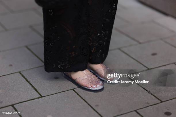 Maria Barteczko seen wearing ARKET black embroidered wide leg trousers and Melissa Possession transparent Jelly fisherman sandals, on July 28, 2024...
