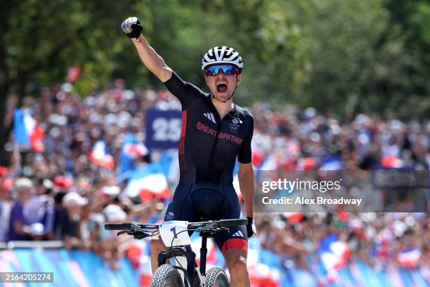 Thomas Pidcock of Team Great Britain celebrates at finish line as gold medal winner during the Men's Cross-Country on day three of the Olympic Games...