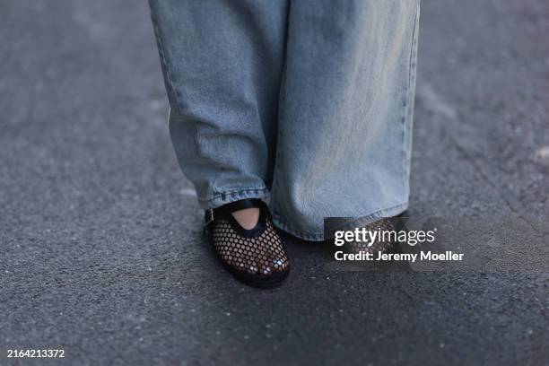 Maria Barteczko seen wearing The Frankie Shop blue belted used baggy jeans and Source Unknown black fishnet ballet flats, on July 28, 2024 in Berlin,...