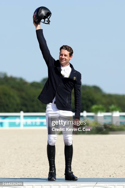 Silver medalist Christopher Burton of Team Australia celebrates during the medal ceremony for the Eventing Jumping Individual Final on day three of...