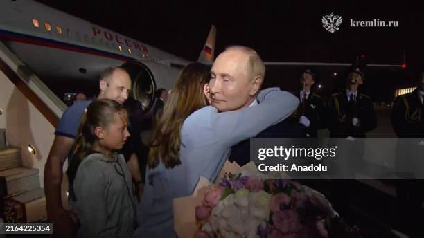 Screen grab from a video released by Kremlin Press Office shows Russian President Vladimir Putin welcomes prisoners released following the swap deal...
