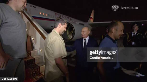 Screen grab from a video released by Kremlin Press Office shows Russian President Vladimir Putin welcomes prisoners released following the swap deal...