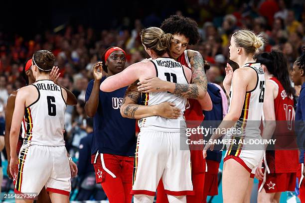 S Brittney Griner hugs Belgium's Emma Meesseman at the end of the women's preliminary round group C basketball match between Belgium and USA during...