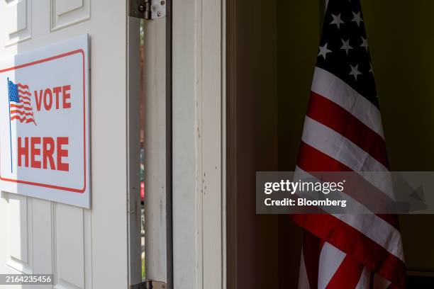 Vote Here" sign at a polling station in East Lansing, Michigan, US, on Thursday, Aug. 1, 2024. Three federal judges on Friday approved a new Michigan...