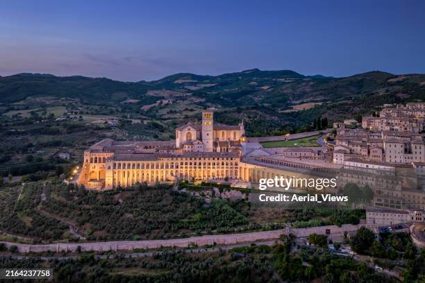 st. francis of assisi basilica illuminated at sunset - assisi stock pictures, royalty-free photos & images