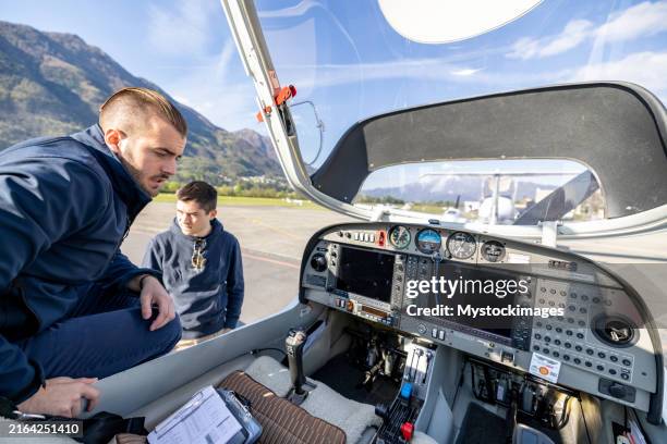 pilots inspecting cockpit before flight - flying school stock pictures, royalty-free photos & images