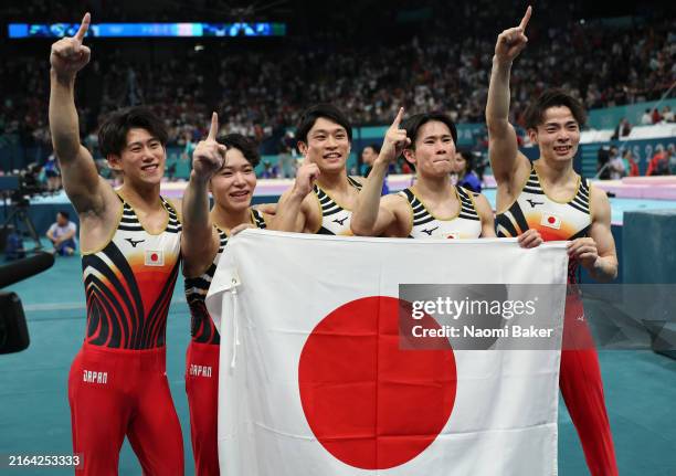Athletes of Team Japan pose for a photo as they celebrate winning the gold medal during the Artistic Gymnastics Men's Team Final on day three of the...
