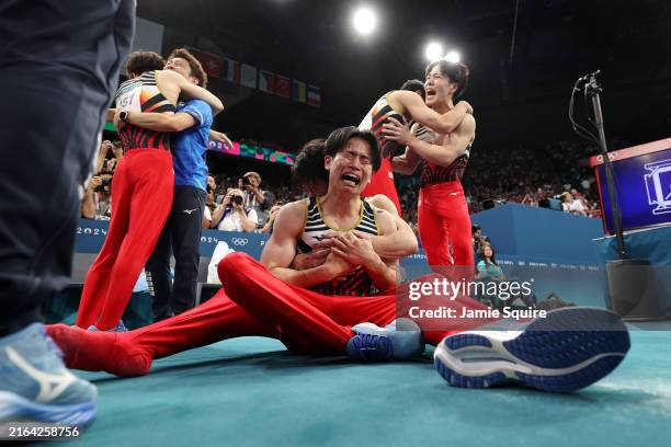 Kazuma Kaya of Team Japan celebrates with teammates after Team Japan won the gold medal during the Artistic Gymnastics Men's Team Final on day three...
