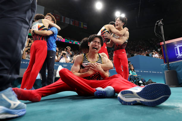 Kazuma Kaya of Team Japan celebrates with teammates after Team Japan won the gold medal during the Artistic Gymnastics Men's Team Final on day three...