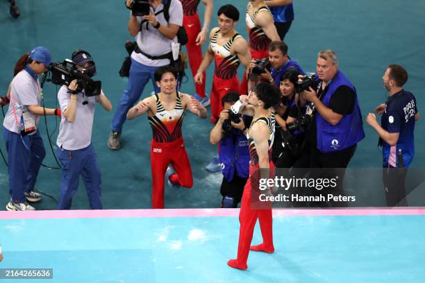 Daiki Hashimoto of Team Japan celebrates after his routine on the high bar during the Artistic Gymnastics Men's Team Final on day three of the...