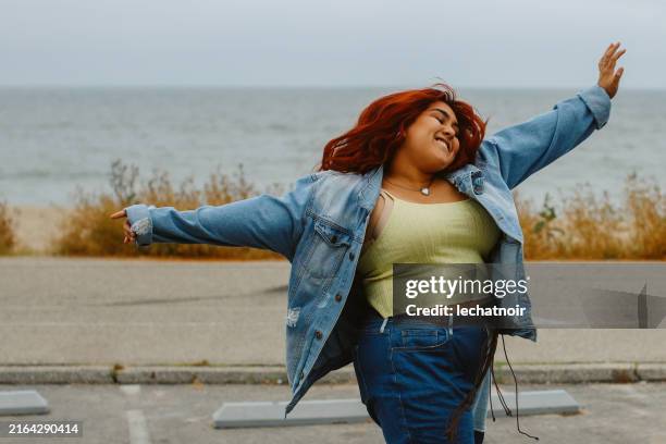 woman dancing near malibu beach, california - plus size stock pictures, royalty-free photos & images