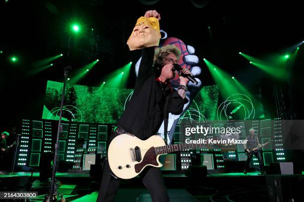 Billie Joe Armstrong of Green Day holds a Donald Trump mask while performing onstage as Green Day kicks off their Saviors North America Stadium Tour...