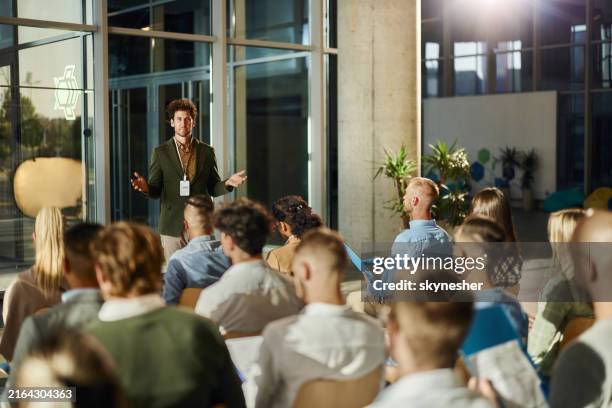 male ceo talking to his colleagues on education event in board room. - congres stockfoto's en -beelden