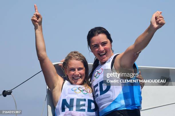 Netherlands' duo Odile Van Aanholt and Annette Duetz celebrate after winning the gold medal at the end of the medal race of the women's 49erFX skiff...