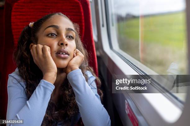bored young girl on the train - sighing stock pictures, royalty-free photos & images