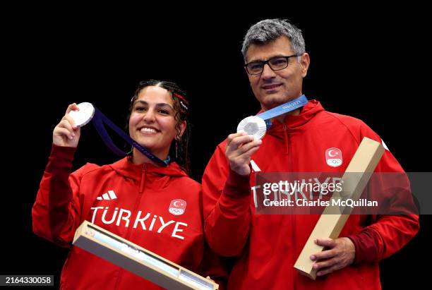 Silver medalists Sevval Ilayda Tarhan and Yusuf Dikec of Team Turkiye pose on the podium during the Shooting 10m Air Pistol Mixed Team medal ceremony...