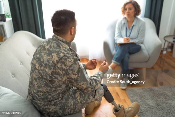 military veteran with prosthetic leg at therapy session. - post traumatic stress disorder stock pictures, royalty-free photos & images
