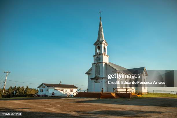 sunset over the church of saint-georges-de-malbaie - gaspe peninsula stock pictures, royalty-free photos & images
