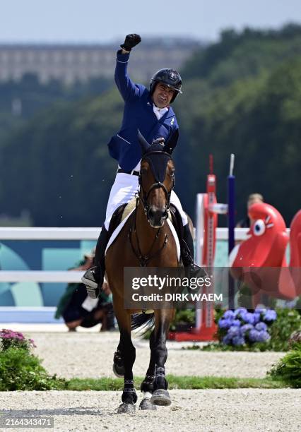 French Olivier Perreau with horse Dorai d'Aiguilly celebrate after their faultless run during the Equestrian Jumping Team final at the Paris 2024...