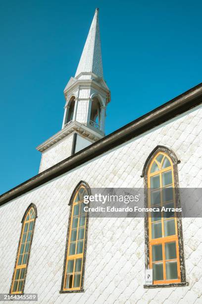 exterior wall, the bell tower and windows of the saint-maurice-de-l'échouerie catholic church - gaspe peninsula stock pictures, royalty-free photos & images