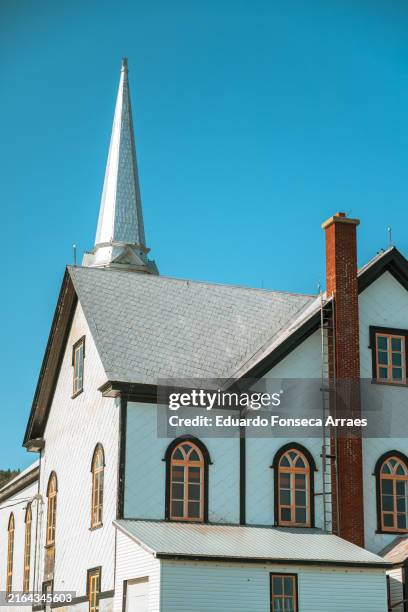 exterior wall, the bell tower and windows of the saint-maurice-de-l'échouerie catholic church - gaspe peninsula stock pictures, royalty-free photos & images