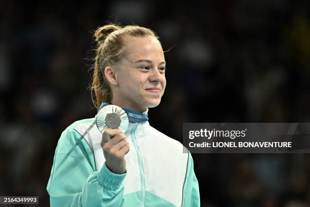 Individual Neutral Athlete Viyaleta Bardzilouskaya poses for pictures holding her silver medal after the women's trampoline gymnastics final of the...