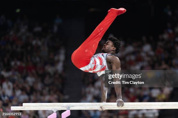 Fred Richard of the United States performs his parallel bars routine during the Artistic Gymnastics Men's Team Final at the Bercy Arena during the...