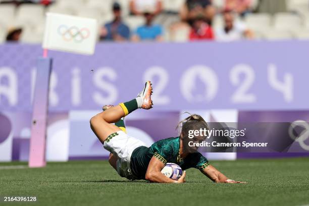Nadine Roos of Team South Africa scores her team's first try during the Women's Rugby Sevens Placing 11-2 match between Team South Africa and Team...