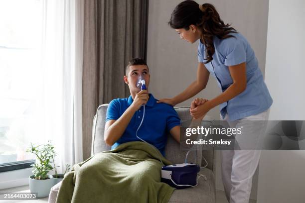 teenager with chronic bronchitis is using inhaler. - chronic obstructive pulmonary disease stock pictures, royalty-free photos & images