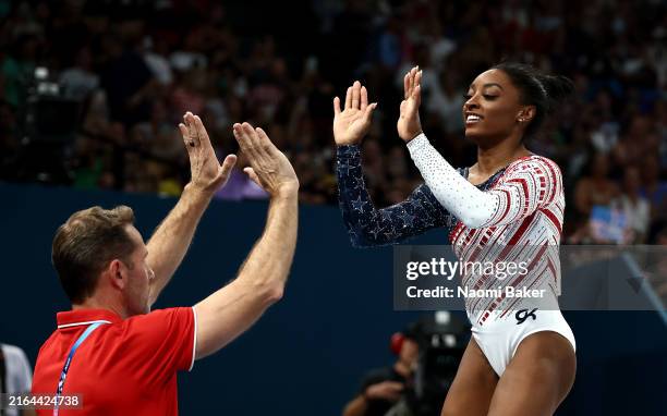 Simone Biles of Team United States reacts with her coach Laurent Landi after competing on the vault during the Artistic Gymnastics Women's Team Final...