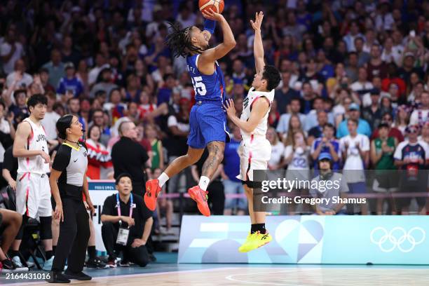 Matthew Strazel of Team France shoots a three point basket basket while being fouled by Yuki Kawamura of Team Japan during a Men's Group Phase-Group...