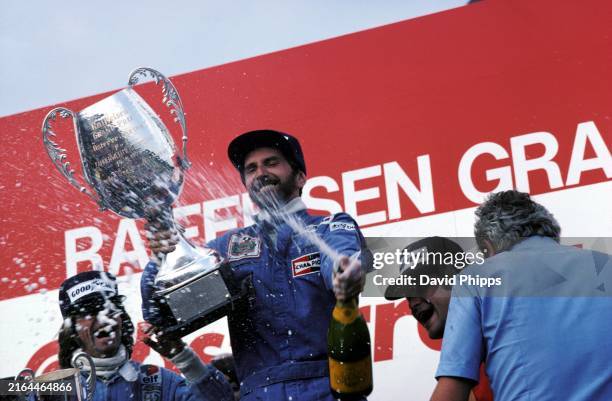 John Watson Penske celebrates his first and PenskeÕs only GP victory on the podium with Jacques Laffite Ligier , who finished second, and Gunnar...