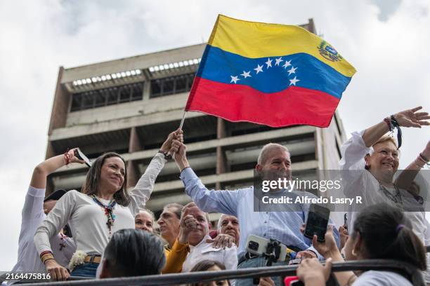 Opposition leader Maria Corina Machado and opposition presidential candidate Edmundo Gonzalez wave a Venezuelan Flag during a protest against the...