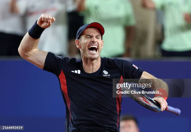 Andy Murray of Team Great Britain celebrates with partner Dan Evans of Team Great Britain after winning match point against Sander Gille of Team...