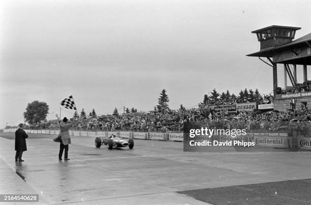 Repco Flags Jack Brabham, Brabham BT19 Repco, taking the chequered flag during ...