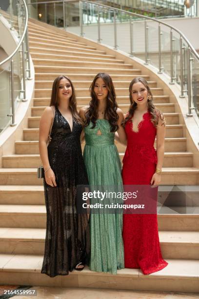 portraits of beautiful graduates friends on the staircase at her graduation party - evening wear stock pictures, royalty-free photos & images