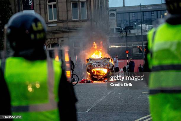 Police car is set on fire as Far-right activists hold an 'Enough is Enough' protest on August 02, 2024 in Sunderland, England. After the murders of...