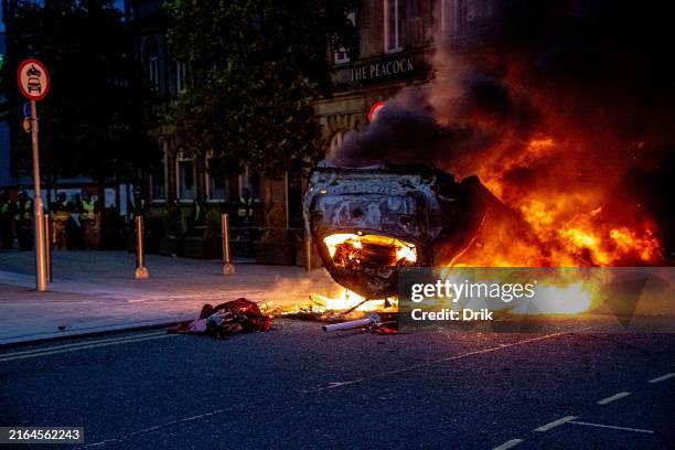 Police car is set on fire as Far-right activists hold an 'Enough is Enough' protest on August 02, 2024 in Sunderland, England. After the murders of...